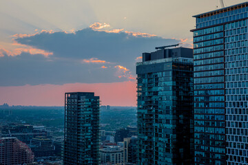 Sunset over city high-rises and skyline reflections © Brendan