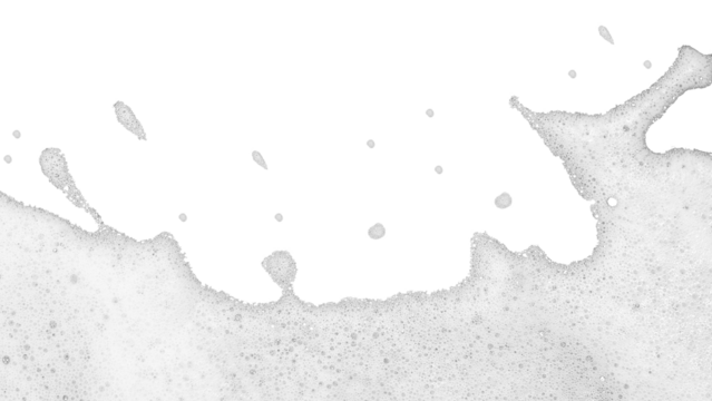 High-key abstract photograph of layer of white foam or suds spreading across bottom portion of pure white background. Foam composed numerous tiny delicate bubbles textured slightly frothy appearance