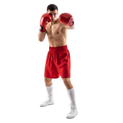 Muscular male boxer in red shorts and gloves posing.