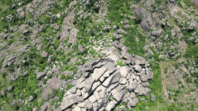 Aerial view of the rugged Shere Hills, where grey rocks meet vibrant green trees, creating a textured tapestry of natural beauty, Shere Hills, Plateau, Nigeria.