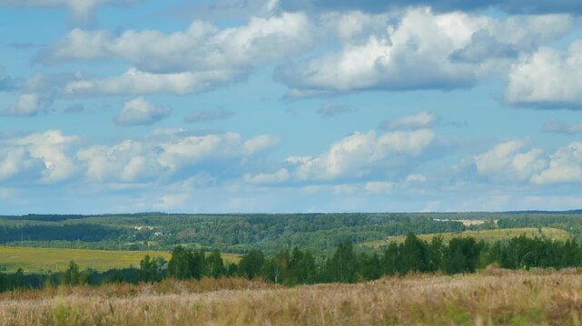A stunningly beautiful landscape featuring rolling hills beneath dramatic, billowing clouds