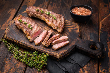 Grilled Tri Tip Steak from Black Angus beef meat. wooden background. top view