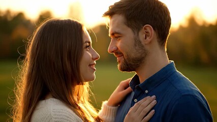 Romantic couple looking at each other during golden hour in a field - Powered by Adobe