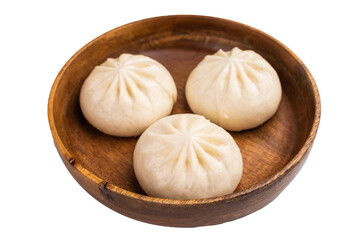 Dumpling Momos with pork meat in wooden plate isolated on white background. top view
