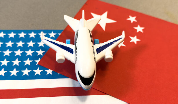 Chinese flag in front of a passenger airplane at the airport, overlaid with financial graphs, symbolizing China global trade, economy, and transportation industry.