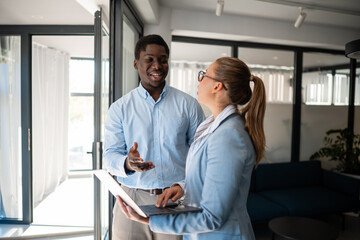 Business colleagues discussing project ideas in modern office