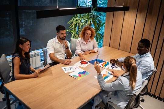 Diverse business team collaborating during creative strategy meeting - Powered by Adobe