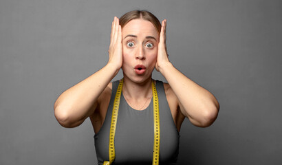 looking excited and surprised, open-mouthed with both hands on head, feeling like a lucky winner....