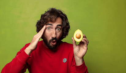 young adult bearded man with an avocado
