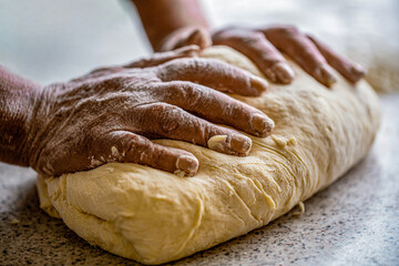 Making dough by male hands at bakery. Food concept. Hands dough. Female hands making dough for pizza. Chef in professional kitchen prepares dough