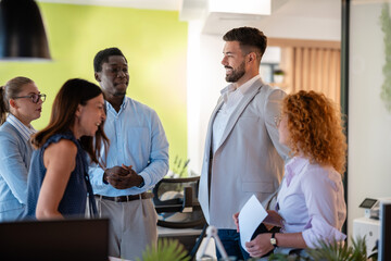 Fototapeta premium Diverse business team having casual discussion in modern office