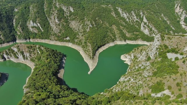 Aerial tilt view of curved meanders in canyon of Uvac river, Serbia, 4k