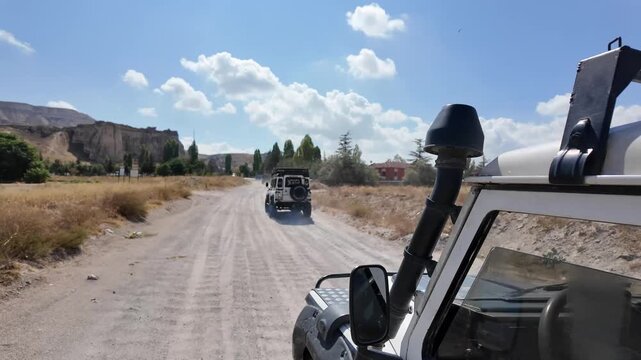 Enjoy a thrilling ride along a bumpy dirt road in a scenic countryside. Experience the beauty of nature while driving through stunning landscapes
