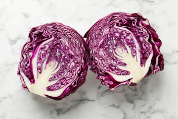 Obraz premium Cut red cabbage on white marble table, top view