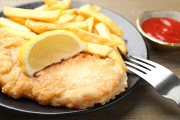 British Traditional Fish and chips served on wooden table, closeup