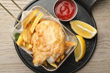 British Traditional Fish and chips served on wooden table, top view