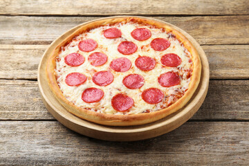 Delicious pepperoni pizza on wooden table, closeup