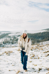 Young girl smiling walking in snowy winter landscape