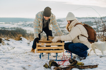 Father daughter gathering firewood for winter camping