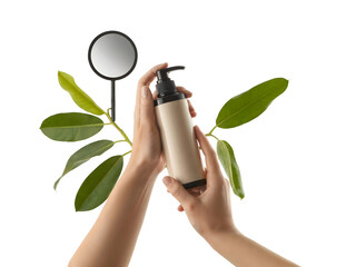 Human hands holding a blank beige cosmetic pump bottle, framed by fresh green foliage and a round mirror isolated on transparent background.