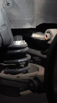 Car suspension spring. A component of a passenger car's suspension.