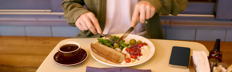 Young man enjoys a delicious meal in a trendy cafe setting