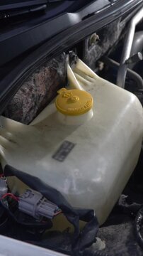 Car windshield washer reservoir. Close-up. Car maintenance.