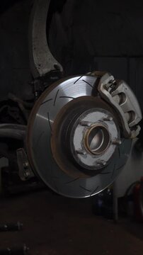 A perforated brake disc installed on a car. Car braking system.