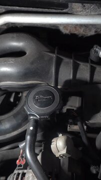 Car engine lubrication system. Where to add oil to a car engine. Engine oil filler neck.