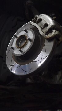 A perforated brake disc installed on a car. Car braking system.