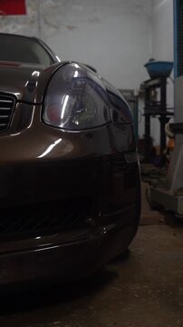 A beautiful brown car at the auto repair shop. Car maintenance and repair.