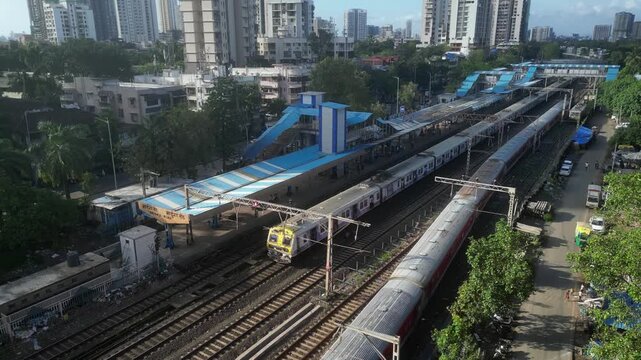 Mumbai local and long distance train passing each other ariel 