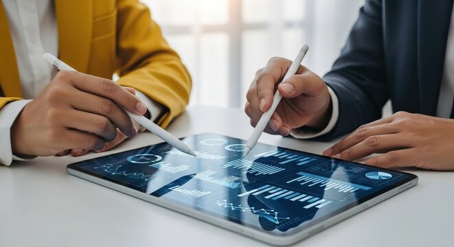 Digital transformation consulting, Two professionals analyze data on a tablet, collaborating with digital pens, modern technology in a business setting.