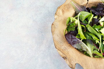 Fresh salad in a rustic wooden bowl.