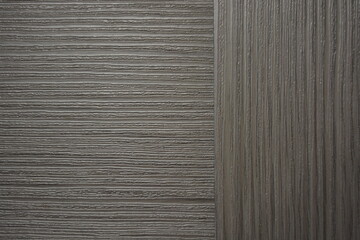 Construction and renovation materials, natural wood background. Gray-brown plastic surface with the texture and relief of wooden planks.