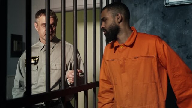 Corrupt guard giving drugs to inmate through cell bars, illegal exchange