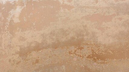 Old car paint surface with cracks, rust stains, and faded texture, showing uneven reddish-brown...