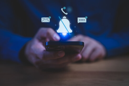 Person holding a smartphone with muted notification bell icon and message, call, and email alerts floating above, symbolizing do not disturb mode, focus time, or silenced notifications.