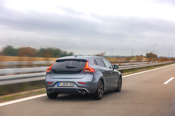Grey hatchback on expressway. Motion and travel.