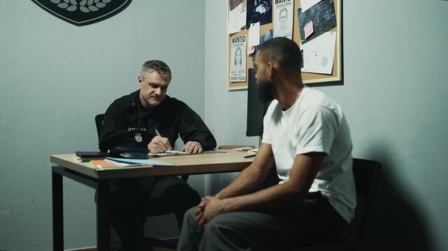 African American male witness giving statement to police officer, interrogation