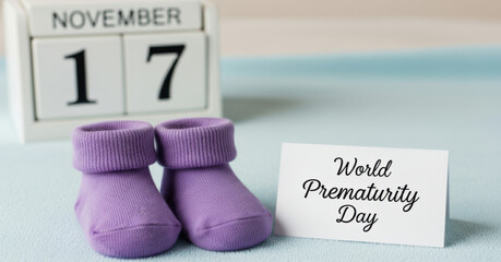 World Prematurity Day, November 17. Awareness banner with tiny purple baby socks