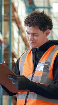 Logistics, worker and writing on clipboard in warehouse for stock inspection, order picking or shipping. Picker, man and happy with notes for inventory management, tracking inbound cargo or low angle