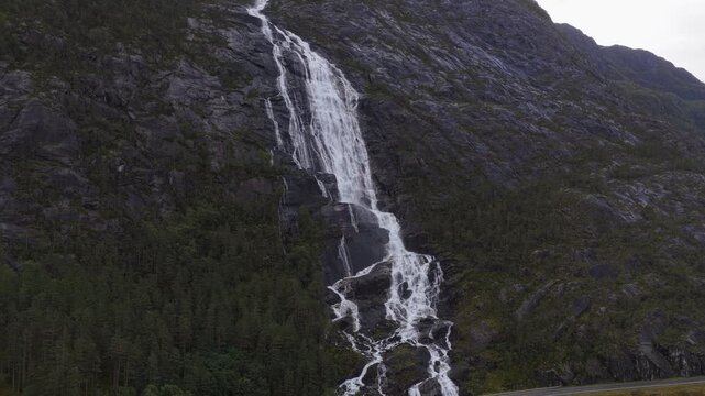 Drone view of Langfossen waterfall plunging through cliffs in Norway