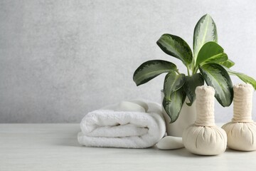 Beautiful spa composition with herbal bags on table against light gray background. Space for text