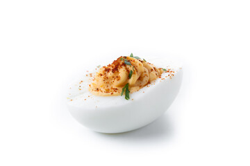 Homemade hard Boiled Deviled Eggs garnished with herbs isolated on white background