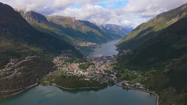 Drone flight above Odda showing rooftops and winding roads