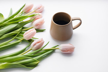 Fresh pink tulips and coffee cup with spring composition.