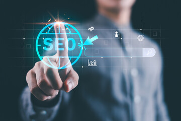 A marketer touching a virtual SEO icon on a transparent digital interface, symbolizing online marketing strategy, search engine optimization, data analytics, and business growth in the digital era.