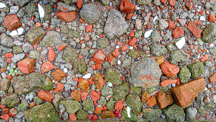 High-resolution texture background of vibrant red brick rubble and gritty gray gravel. This authentic surface is excellent for rustic, industrial, architectural, construction, and digital design needs