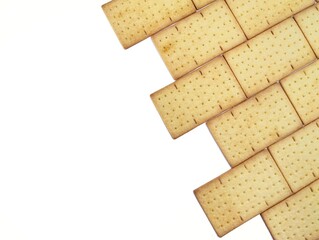 Pile of square biscuits crackers isolated on white background. Copy space	